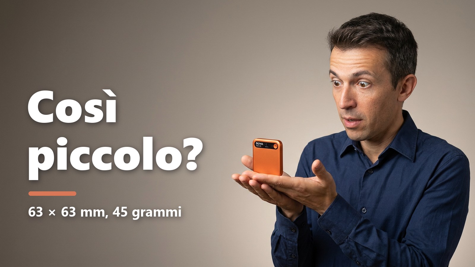 Maurizio Pelizzone stupito con il BOYA Notra arancione nel palmo della mano, immagine generata con l'intelligenza artificiale